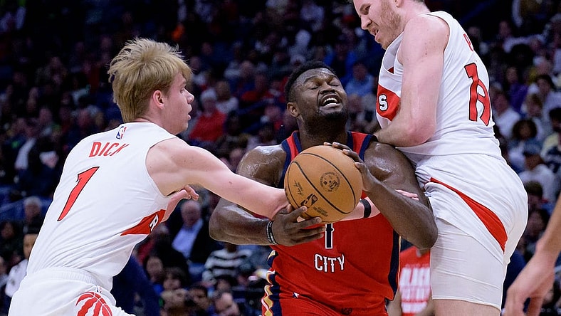 Feb 5, 2024; New Orleans, Louisiana, USA; Toronto Raptors guard Gradey Dick (1) and Toronto Raptors center Jakob Poeltl (19) double team New Orleans Pelicans forward Zion Williamson (1) during the first half at Smoothie King Center. Mandatory Credit: Matthew Hinton-USA TODAY Sports