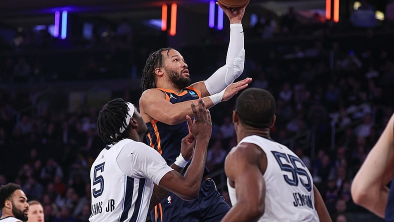 Feb 6, 2024; New York, New York, USA; New York Knicks guard Jalen Brunson (11) drives to the basket against Memphis Grizzlies forward Vince Williams Jr. and center Trey Jemison (55) during the first quarter at Madison Square Garden. Mandatory Credit: Vincent Carchietta-USA TODAY Sports
