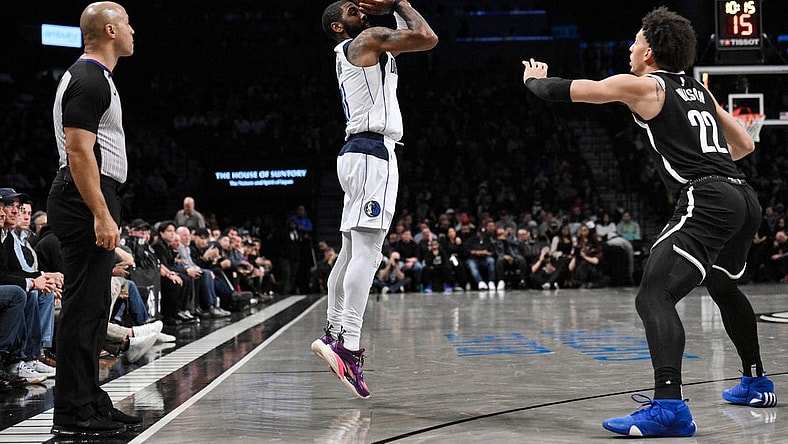 Feb 6, 2024; Brooklyn, New York, USA; Dallas Mavericks guard Kyrie Irving (11) shoots as Brooklyn Nets forward Jalen Wilson (22) defends during the second quarter at Barclays Center. Mandatory Credit: John Jones-USA TODAY Sports