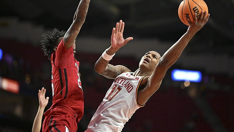 Feb 6, 2024; College Park, Maryland, USA; Maryland Terrapins forward Julian Reese (10) shoots as Rutgers Scarlet Knights center Emmanuel Ogbole (22) defends the basket during the second half  at Xfinity Center. Mandatory Credit: Tommy Gilligan-USA TODAY Sports