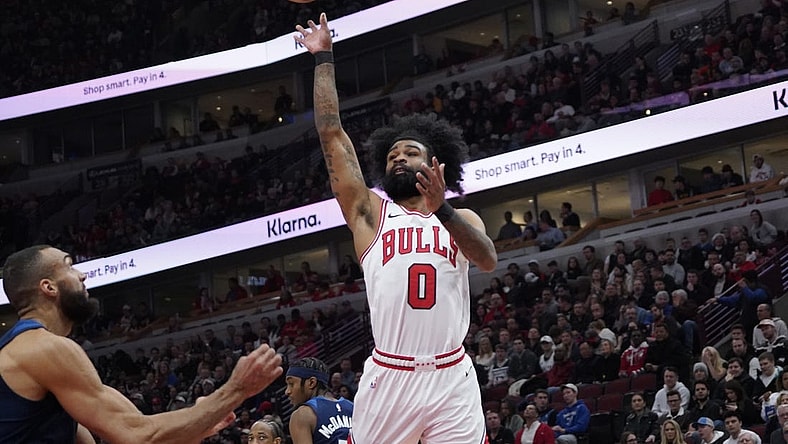 Feb 6, 2024; Chicago, Illinois, USA; Chicago Bulls guard Coby White (0) shoots over Minnesota Timberwolves center Rudy Gobert (27) during the first quarter at United Center. Mandatory Credit: David Banks-USA TODAY Sports