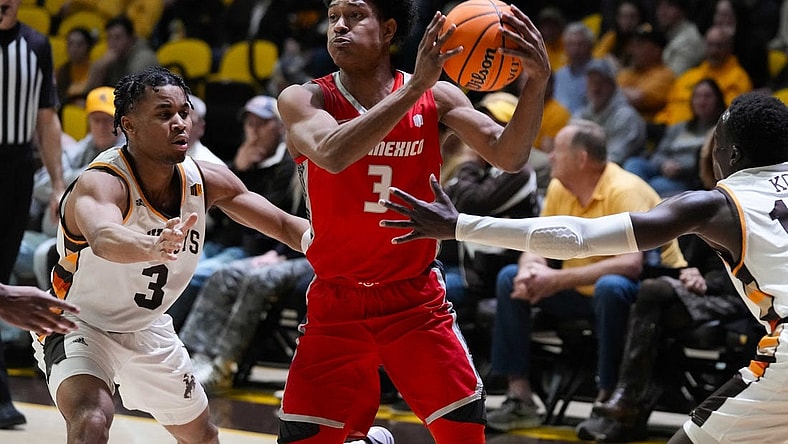 Feb 6, 2024; Laramie, Wyoming, USA; New Mexico Lobos guard Tru Washington (3) looks to pass against Wyoming Cowboys guard Sam Griffin (3) during the first half at Arena-Auditorium. Mandatory Credit: Troy Babbitt-USA TODAY Sports