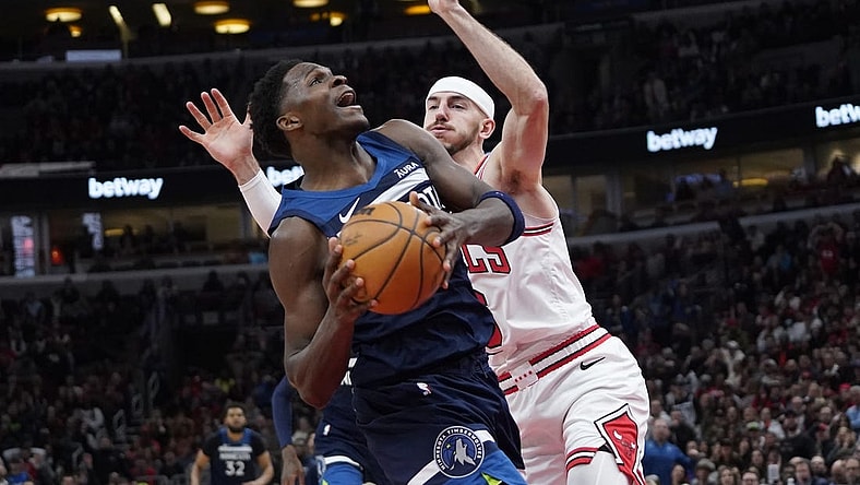Feb 6, 2024; Chicago, Illinois, USA; Chicago Bulls guard Alex Caruso (6) defends Minnesota Timberwolves guard Anthony Edwards (5) during the second half at United Center. Mandatory Credit: David Banks-USA TODAY Sports