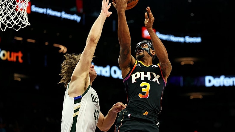 Feb 6, 2024; Phoenix, Arizona, USA; Phoenix Suns guard Bradley Beal (3) shoots the ball against Milwaukee Bucks center Robin Lopez (42) during the third quarter at Footprint Center. Mandatory Credit: Mark J. Rebilas-USA TODAY Sports