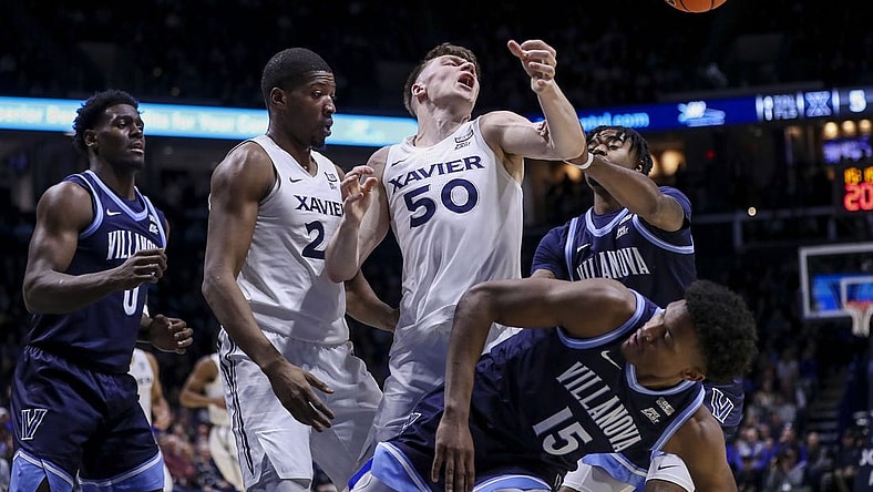 Feb 7, 2024; Cincinnati, Ohio, USA; Xavier Musketeers forward Gytis Nemeiksa (50) battles for the ball against Villanova Wildcats guard Jordan Longino (15) in the first half at Cintas Center. Mandatory Credit: Katie Stratman-USA TODAY Sports
