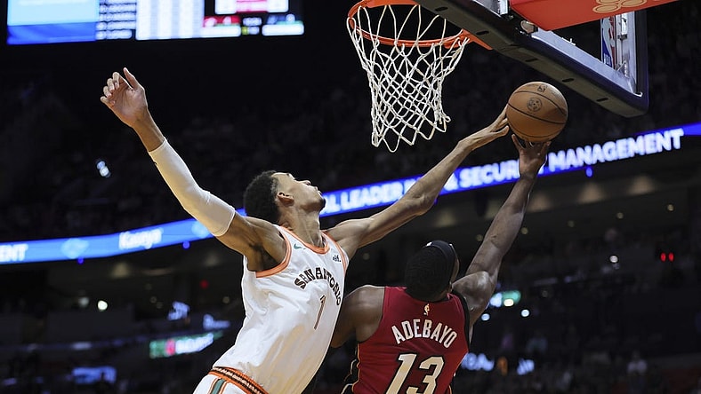 Feb 7, 2024; Miami, Florida, USA; San Antonio Spurs center Victor Wembanyama (1) blocks a shot against Miami Heat center Bam Adebayo (13) during the first quarter at Kaseya Center. Mandatory Credit: Sam Navarro-USA TODAY Sports