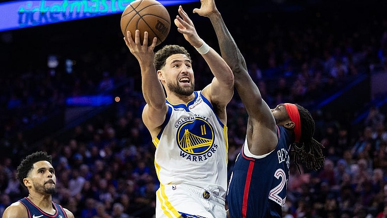 Feb 7, 2024; Philadelphia, Pennsylvania, USA; Golden State Warriors guard Klay Thompson (11) scores past Philadelphia 76ers guard Patrick Beverley (22) during the third quarter at Wells Fargo Center. Mandatory Credit: Bill Streicher-USA TODAY Sports