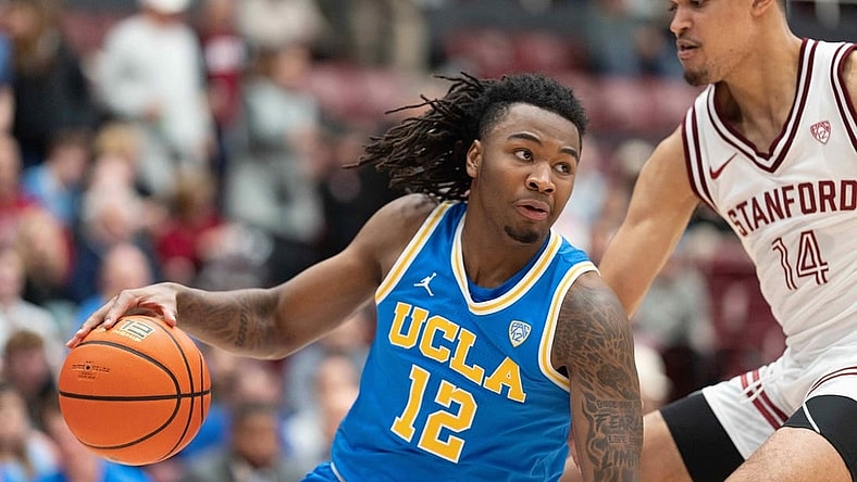 Feb 7, 2024; Stanford, California, USA;  UCLA Bruins guard Sebastian Mack (12) controls the ball during the second half against Stanford Cardinal forward Spencer Jones (14) at Maples Pavilion. Mandatory Credit: Stan Szeto-USA TODAY Sports