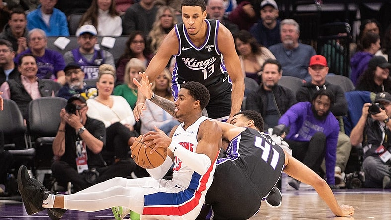 Feb 7, 2024; Sacramento, California, USA; Detroit Pistons guard Jaden Ivey (23) and Sacramento Kings forward Trey Lyles (41) fight for possession of the ball during the second quarter at Golden 1 Center. Mandatory Credit: Ed Szczepanski-USA TODAY Sports