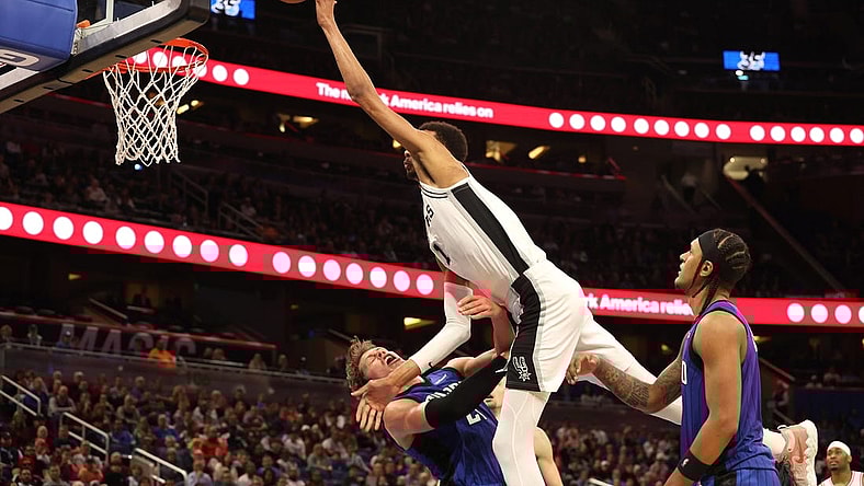 Feb 8, 2024; Orlando, Florida, USA;  Orlando Magic center Moritz Wagner (21) fouls San Antonio Spurs center Victor Wembanyama (1) during the second half at Kia Center. Mandatory Credit: Kim Klement Neitzel-USA TODAY Sports