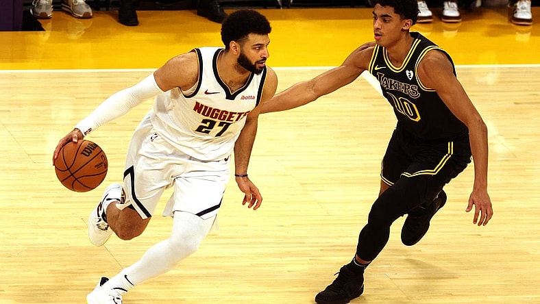 Feb 8, 2024; Los Angeles, California, USA; Denver Nuggets guard Jamal Murray (27) dribbles against Los Angeles Lakers guard Max Christie (10) during the first quarter at Crypto.com Arena. Mandatory Credit: Jason Parkhurst-USA TODAY Sports