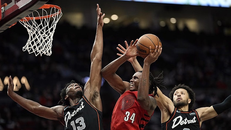 Feb 8, 2024; Portland, Oregon, USA; Portland Trail Blazers forward Jabari Walker (34) shoots the ball against Detroit Pistons center James Wiseman (13) and point guard Cade Cunningham (2) during the second half at Moda Center. Mandatory Credit: Soobum Im-USA TODAY Sports