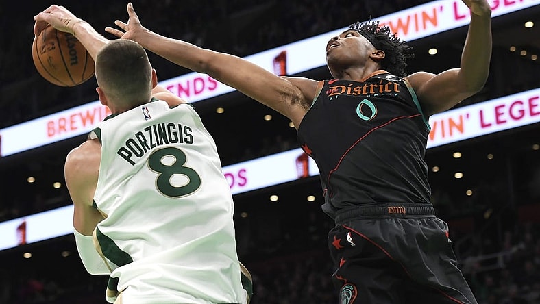 Feb 9, 2024; Boston, Massachusetts, USA; Boston Celtics center Kristaps Porzingis (8) blocks the shot of Washington Wizards guard Bilal Coulibaly (0) during the first half at TD Garden. Mandatory Credit: Bob DeChiara-USA TODAY Sports