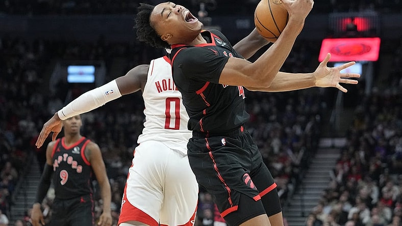 Feb 9, 2024; Toronto, Ontario, CAN; Toronto Raptors forward Scottie Barnes (4) pulls in a pass against Houston Rockets guard Aaron Holiday (0) during the first half at Scotiabank Arena. Mandatory Credit: John E. Sokolowski-USA TODAY Sports