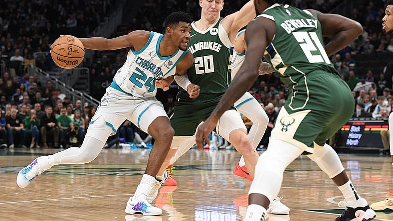 Feb 9, 2024; Milwaukee, Wisconsin, USA; Charlotte Hornets forward Brandon Miller (24) drives against  Milwaukee Bucks guard AJ Green (20) and guard Patrick Beverley (21) in the first half at Fiserv Forum. Mandatory Credit: Michael McLoone-USA TODAY Sports