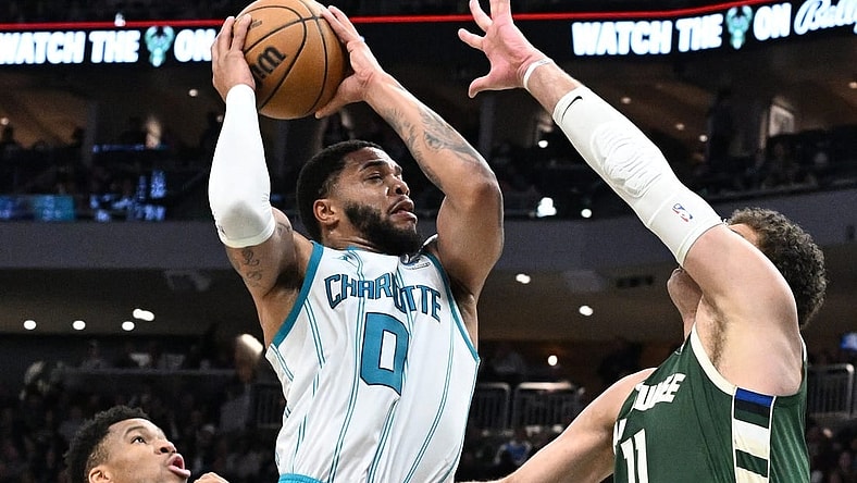 Feb 9, 2024; Milwaukee, Wisconsin, USA; Charlotte Hornets forward Miles Bridges (0) drives to the basket against Milwaukee Bucks center Brook Lopez (11) in the first half at Fiserv Forum. Mandatory Credit: Michael McLoone-USA TODAY Sports