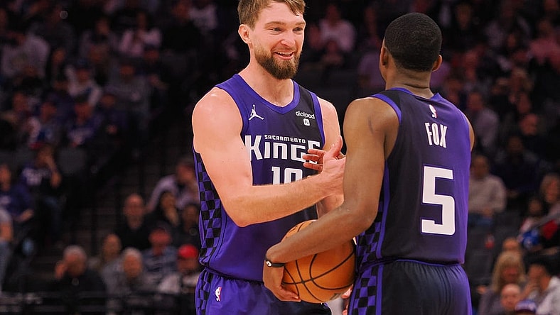 Feb 9, 2024; Sacramento, California, USA; Sacramento Kings center Domantas Sabonis (10) smiles with guard De'Aaron Fox (5) after a play against the Denver Nuggets during the second quarter at Golden 1 Center. Mandatory Credit: Kelley L Cox-USA TODAY Sports