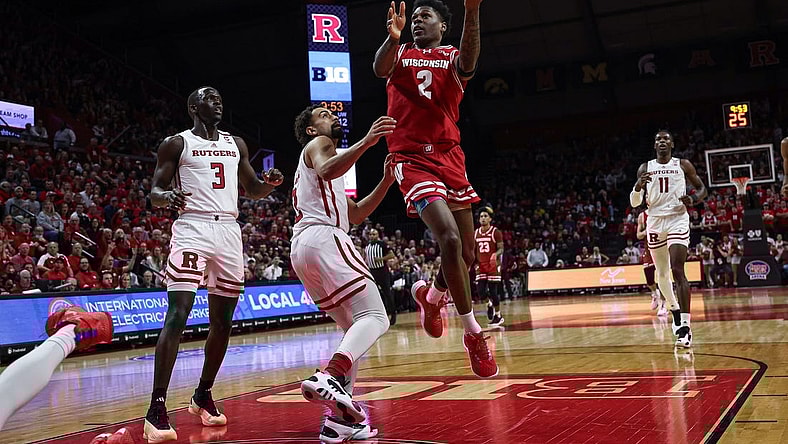 Feb 10, 2024; Piscataway, New Jersey, USA; Wisconsin Badgers guard AJ Storr (2) drives for a shot against Rutgers Scarlet Knights guard Noah Fernandes (2) and forward Mawot Mag (3) during the first half at Jersey Mike's Arena. Mandatory Credit: Vincent Carchietta-USA TODAY Sports