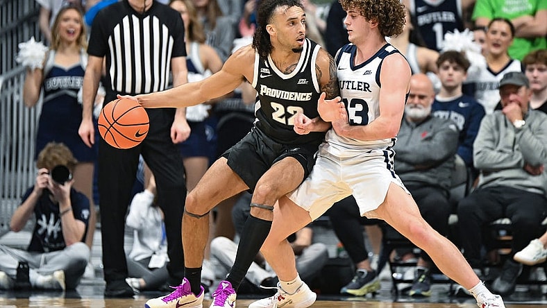 Feb 10, 2024; Indianapolis, Indiana, USA;  Providence Friars guard Devin Carter (22) dribbles against Butler Bulldogs guard Finley Bizjack (13) during the first half at Hinkle Fieldhouse. Mandatory Credit: Robert Goddin-USA TODAY Sports