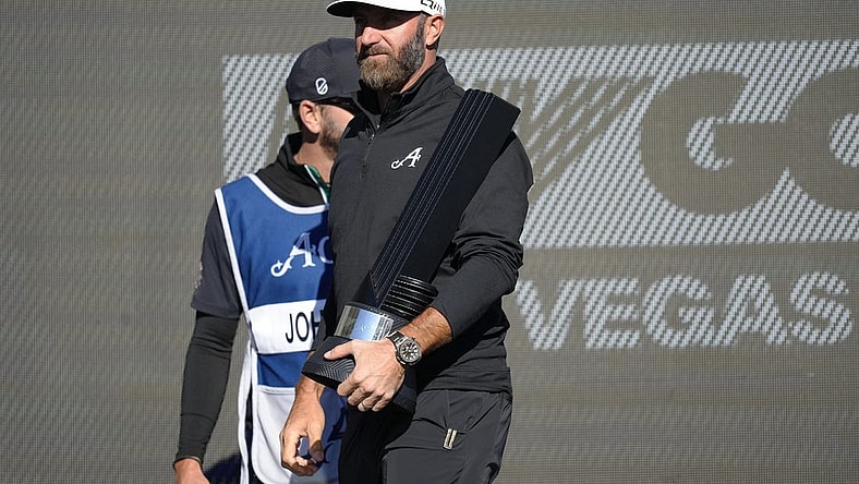Feb 10, 2024; Las Vegas, Nevada, USA; Dustin Johnson holds the individual championship trophy after winning the LIV Golf Las Vegas tournament at Las Vegas Country Club. Mandatory Credit: Lucas Peltier-USA TODAY Sports