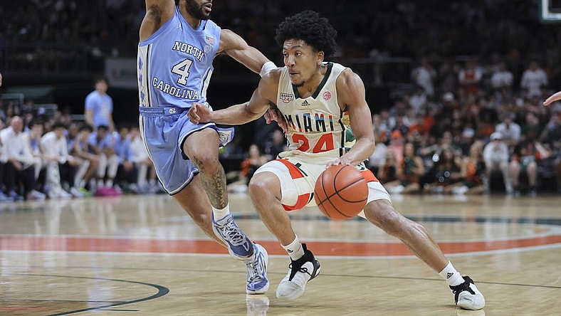 Feb 10, 2024; Coral Gables, Florida, USA; Miami Hurricanes guard Nijel Pack (24) drives to the basket past North Carolina Tar Heels guard RJ Davis (4) during the second half at Watsco Center. Mandatory Credit: Sam Navarro-USA TODAY Sports