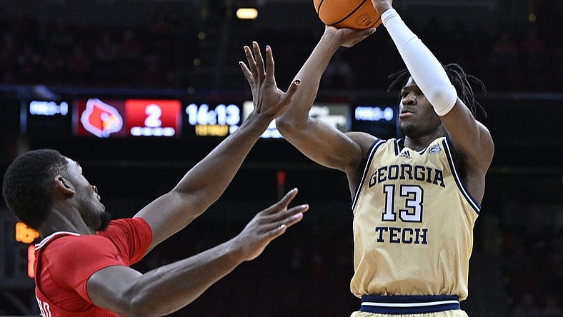 Feb 10, 2024; Louisville, Kentucky, USA; Georgia Tech Yellow Jackets guard Miles Kelly (13) shoots against Louisville Cardinals forward Brandon Huntley-Hatfield (5) during the first half at KFC Yum! Center. Mandatory Credit: Jamie Rhodes-USA TODAY Sports
