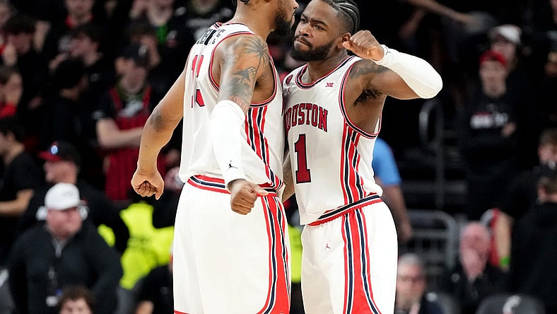 Houston Cougars forward J'Wan Roberts (13) and Houston Cougars guard Jamal Shead (1) celebrate the win at the conclusion of the second half of an NCAA college basketball game against the Cincinnati Bearcats, Saturday, Feb. 10, 2024, at Fifth Third Arena in Cincinnati.