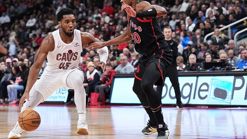 Feb 10, 2024; Toronto, Ontario, CAN; Cleveland Cavaliers guard Donovan Mitchell (45) controls the ball as Toronto Raptors guard Ochai Agbaji (30) tries to defend during the second quarter at Scotiabank Arena . Mandatory Credit: Nick Turchiaro-USA TODAY Sports