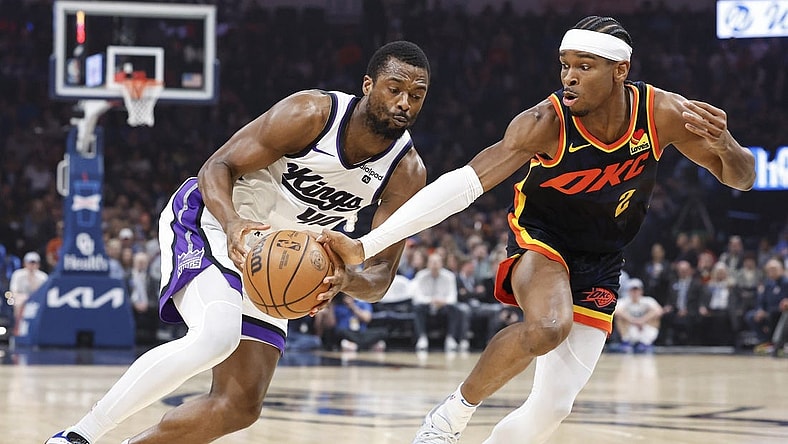 Feb 11, 2024; Oklahoma City, Oklahoma, USA; Oklahoma City Thunder guard Shai Gilgeous-Alexander (2) reaches to steal the ball from Sacramento Kings forward Harrison Barnes (40) during the first quarter at Paycom Center. Mandatory Credit: Alonzo Adams-USA TODAY Sports