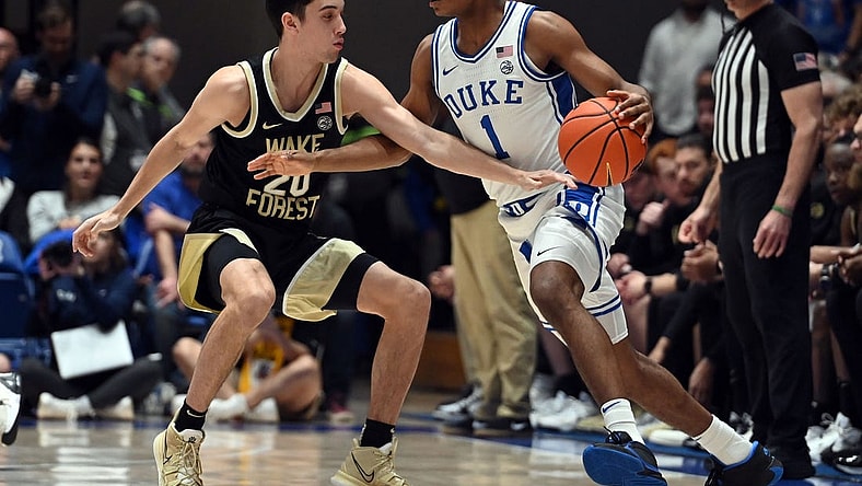 Feb 12, 2024; Durham, North Carolina, USA;  Duke Blue Devils guard Caleb Foster (1) controls the ball in front of Wake Forest Deamon Deacons guard Parker Friedrichsen (20) during the first half at Cameron Indoor Stadium. Mandatory Credit: Rob Kinnan-USA TODAY Sports