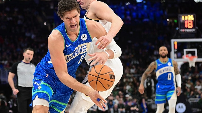 Feb 12, 2024; Milwaukee, Wisconsin, USA;  Milwaukee Bucks center Brook Lopez (11) tries to get past Denver Nuggets center Nikola Jokic (15) in the first quarter at Fiserv Forum. Mandatory Credit: Benny Sieu-USA TODAY Sports