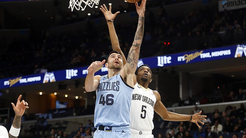 Feb 12, 2024; Memphis, Tennessee, USA; Memphis Grizzlies guard John Konchar (46) shoots as New Orleans Pelicans forward Herbert Jones (5) defends during the first half at FedExForum. Mandatory Credit: Petre Thomas-USA TODAY Sports