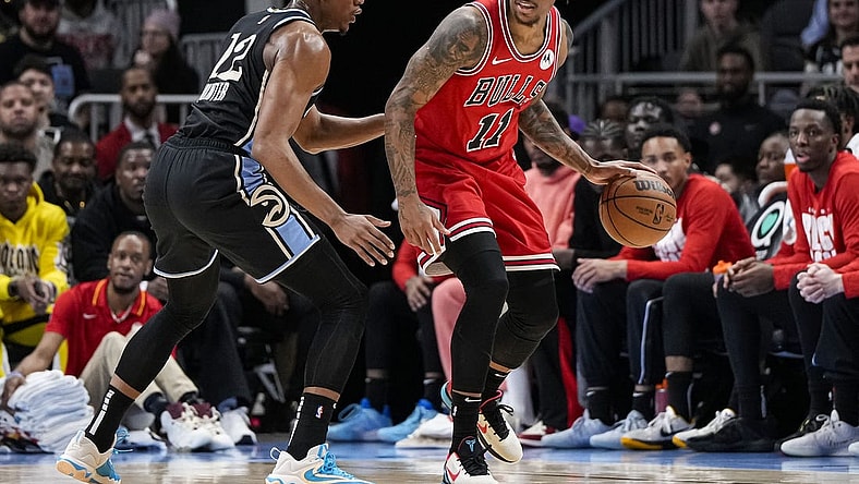 Feb 12, 2024; Atlanta, Georgia, USA; Chicago Bulls forward DeMar DeRozan (11) dribbles against Atlanta Hawks forward De'Andre Hunter (12) during the first half at State Farm Arena. Mandatory Credit: Dale Zanine-USA TODAY Sports