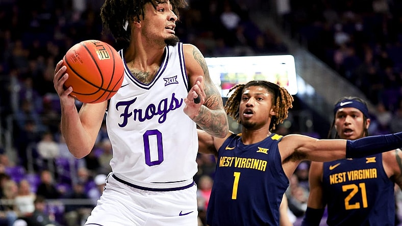 Feb 12, 2024; Fort Worth, Texas, USA;  TCU Horned Frogs guard Micah Peavy (0) looks to pass as West Virginia Mountaineers guard Noah Farrakhan (1) defends during the first half at Ed and Rae Schollmaier Arena. Mandatory Credit: Kevin Jairaj-USA TODAY Sports