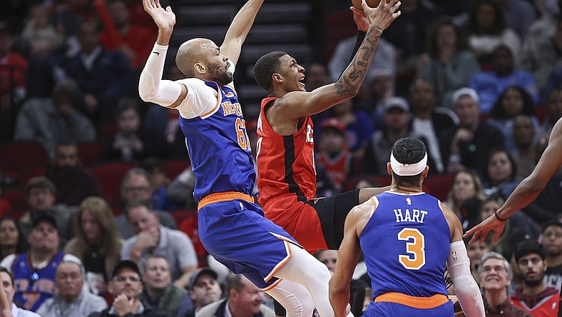 Feb 12, 2024; Houston, Texas, USA; Houston Rockets forward Jabari Smith Jr. (10) grabs a rebound away from New York Knicks forward Taj Gibson (67) during the second quarter at Toyota Center. Mandatory Credit: Troy Taormina-USA TODAY Sports