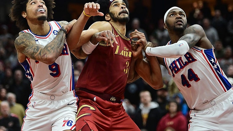 Feb 12, 2024; Cleveland, Ohio, USA; Cleveland Cavaliers center Jarrett Allen (31) fights for position against Philadelphia 76ers guard Kelly Oubre Jr. (9) and forward Paul Reed (44) during the second half at Rocket Mortgage FieldHouse. Mandatory Credit: Ken Blaze-USA TODAY Sports