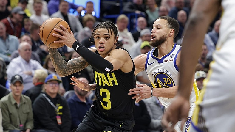 Feb 12, 2024; Salt Lake City, Utah, USA;  Utah Jazz guard Keyonte George (3) tries to get away from Golden State Warriors guard Stephen Curry (30) during the first quarter at Delta Center. Mandatory Credit: Chris Nicoll-USA TODAY Sports