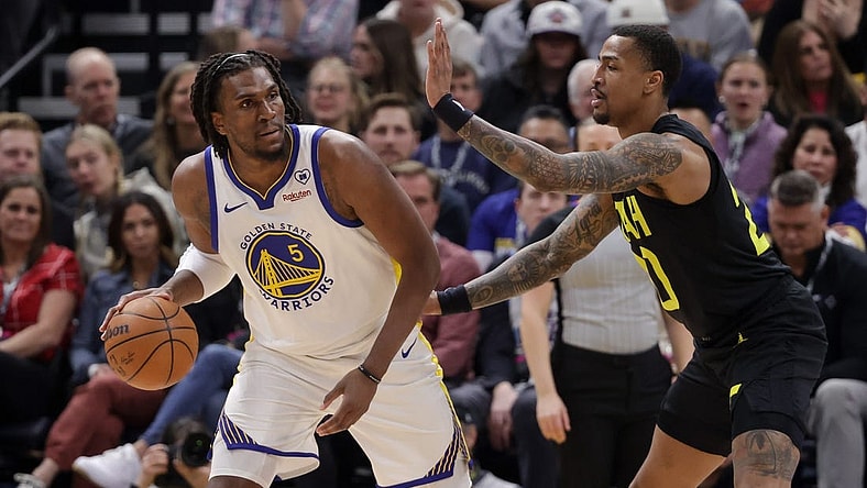 Feb 12, 2024; Salt Lake City, Utah, USA;  Golden State Warriors forward Kevon Looney (5) controls the ball from Utah Jazz forward John Collins (20) during the first quarter at Delta Center. Mandatory Credit: Chris Nicoll-USA TODAY Sports