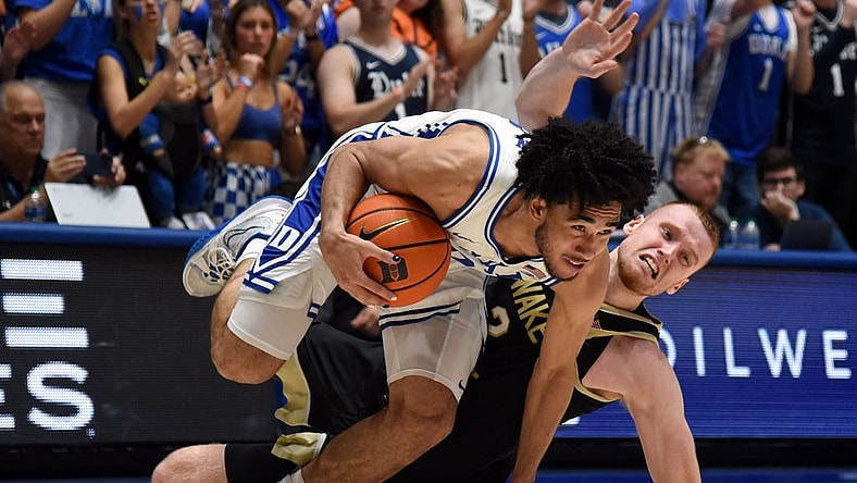 Feb 12, 2024; Durham, North Carolina, USA; Duke Blue Devils guard Jared McCain (0) is fouled as he drives against Wake Forest Deamon Deacons guard Cameron Hildreth (2) during the second half at Cameron Indoor Stadium. The Blue Devils won 77-69. Mandatory Credit: Rob Kinnan-USA TODAY Sports