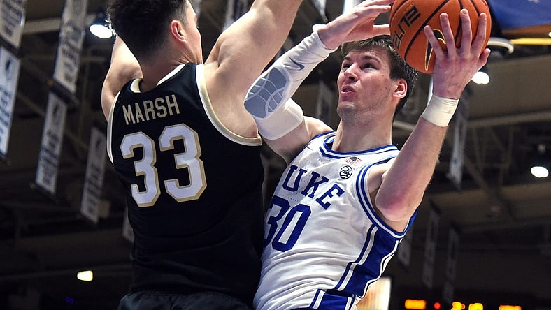 Feb 12, 2024; Durham, North Carolina, USA; Duke Blue Devils center Kyle Filipowski (30) shoots over Wake Forest Deamon Deacons center Matthew Marsh (33) during the second half at Cameron Indoor Stadium. The Blue Devils won 77-69. Mandatory Credit: Rob Kinnan-USA TODAY Sports