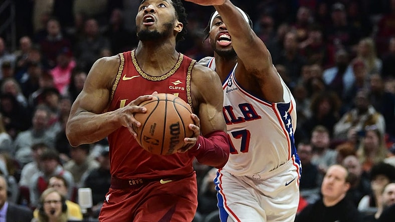 Feb 12, 2024; Cleveland, Ohio, USA; Cleveland Cavaliers guard Donovan Mitchell (45) drives to the basket against Philadelphia 76ers guard Buddy Hield (17) during the second half at Rocket Mortgage FieldHouse. Mandatory Credit: Ken Blaze-USA TODAY Sports