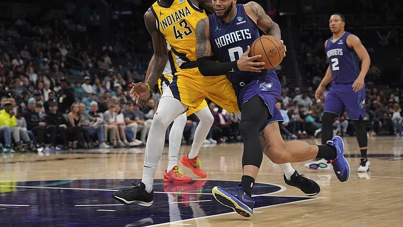 Feb 12, 2024; Charlotte, North Carolina, USA; Charlotte Hornets forward Miles Bridges (0) drives to the basket guarded by Indiana Pacers forward Pascal Siakam (43) during the second half at Spectrum Center. Mandatory Credit: Jim Dedmon-USA TODAY Sports