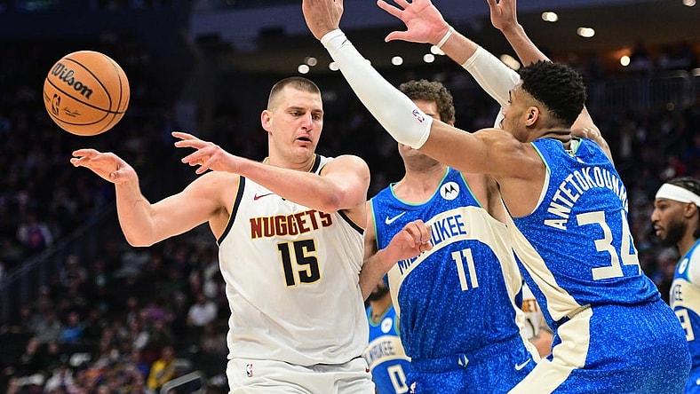 Feb 12, 2024; Milwaukee, Wisconsin, USA; Denver Nuggets center Nikola Jokic (15) passes against Milwaukee Bucks forward Giannis Antetokounmpo (34) in the third quarter at Fiserv Forum. Mandatory Credit: Benny Sieu-USA TODAY Sports