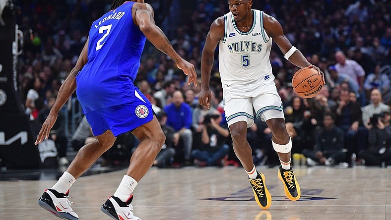 Feb 12, 2024; Los Angeles, California, USA; Minnesota Timberwolves guard Anthony Edwards (5) controls the ball against Los Angeles Clippers forward Kawhi Leonard (2) during the first half at Crypto.com Arena. Mandatory Credit: Gary A. Vasquez-USA TODAY Sports