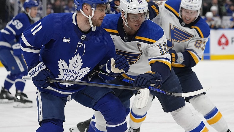 Feb 13, 2024; Toronto, Ontario, CAN; Toronto Maple Leafs forward Max Domi (11) and St. Louis Blues forward Brayden Schenn (10) battle for position during the second period Scotiabank Arena. Mandatory Credit: John E. Sokolowski-USA TODAY Sports