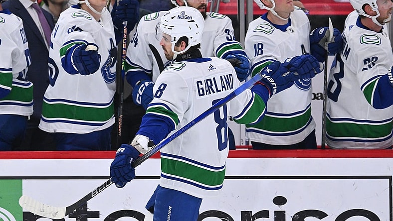 Feb 13, 2024; Chicago, Illinois, USA;  Vancouver Canucks forward Conor Garland (8) celebrates with the bench after scoring a goal in the first period against the Chicago Blackhawks at United Center. Mandatory Credit: Jamie Sabau-USA TODAY Sports