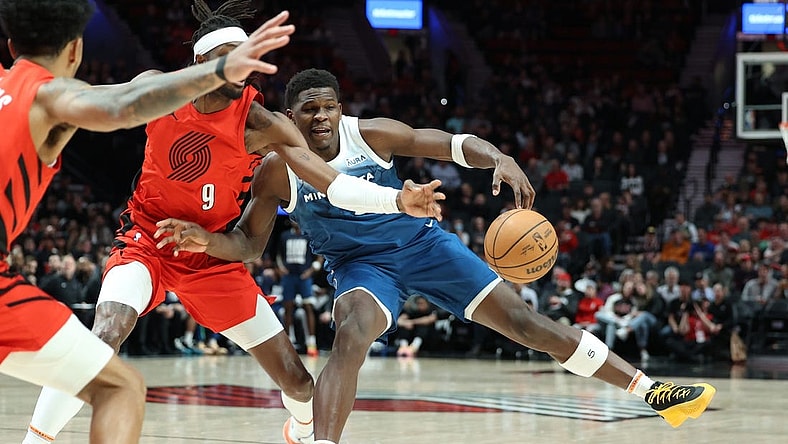 Feb 13, 2024; Portland, Oregon, USA; Minnesota Timberwolves guard Anthony Edwards (5) fights for possession against Portland Trail Blazers forward Jerami Grant (9) in the first quarter at Moda Center. Mandatory Credit: Jaime Valdez-USA TODAY Sports