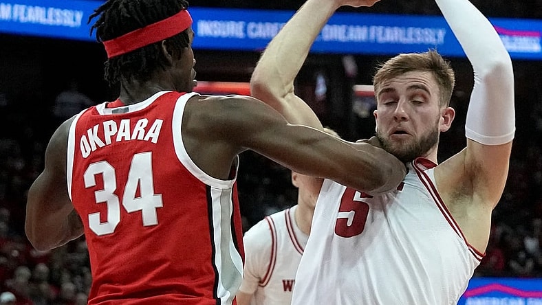 Feb 13, 2024; Madison, Wisconsin, USA;. Ohio State center Felix Okpara (34) grads Wisconsin forward Tyler Wahl (5) during the second half of their game at the Kohl Center. Mandatory Credit: Mark Hoffman/Milwaukee Journal Sentinelf-USA TODAY Sports