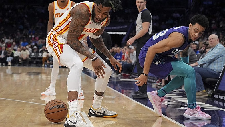 Feb 14, 2024; Charlotte, North Carolina, USA; Atlanta Hawks forward Saddiq Bey (41) loses the ball defended by Charlotte Hornets guard Tre Mann (23) during the second quarter at Spectrum Center. Mandatory Credit: Jim Dedmon-USA TODAY Sports