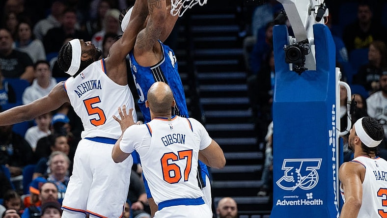 Feb 14, 2024; Orlando, Florida, USA; Orlando Magic forward Paolo Banchero (5) dunks the ball against New York Knicks forward Precious Achiuwa (5) in the second quarter at KIA Center. Mandatory Credit: Jeremy Reper-USA TODAY Sports